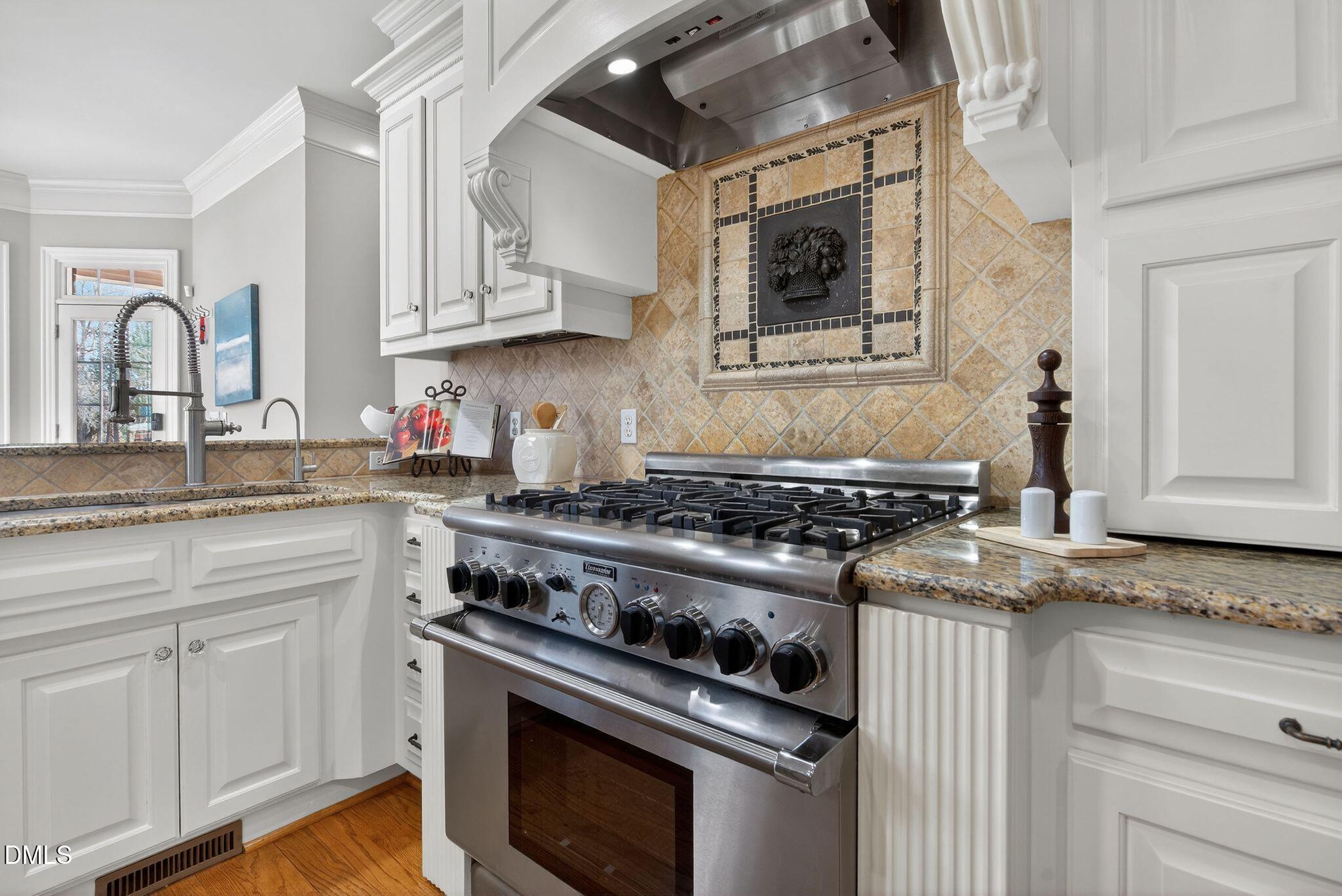 1609 Holland Road Fuquay-Varina, NC 27526 - Photo 17 of 79 a kitchen with stainless steel appliances granite countertop a stove and a sink