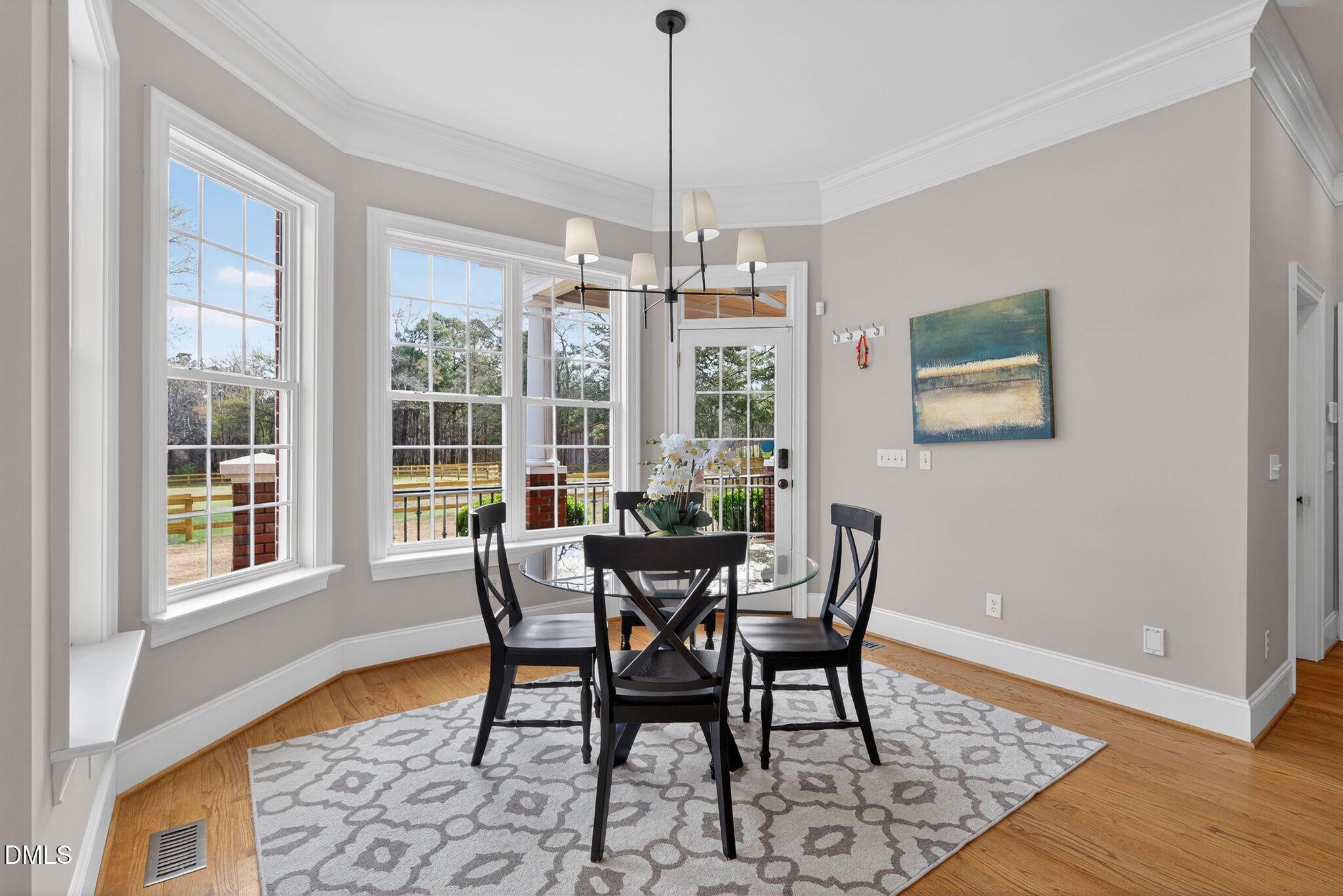 1609 Holland Road Fuquay-Varina, NC 27526 - Photo 19 of 79 a view of a dining room with furniture window and wooden floor