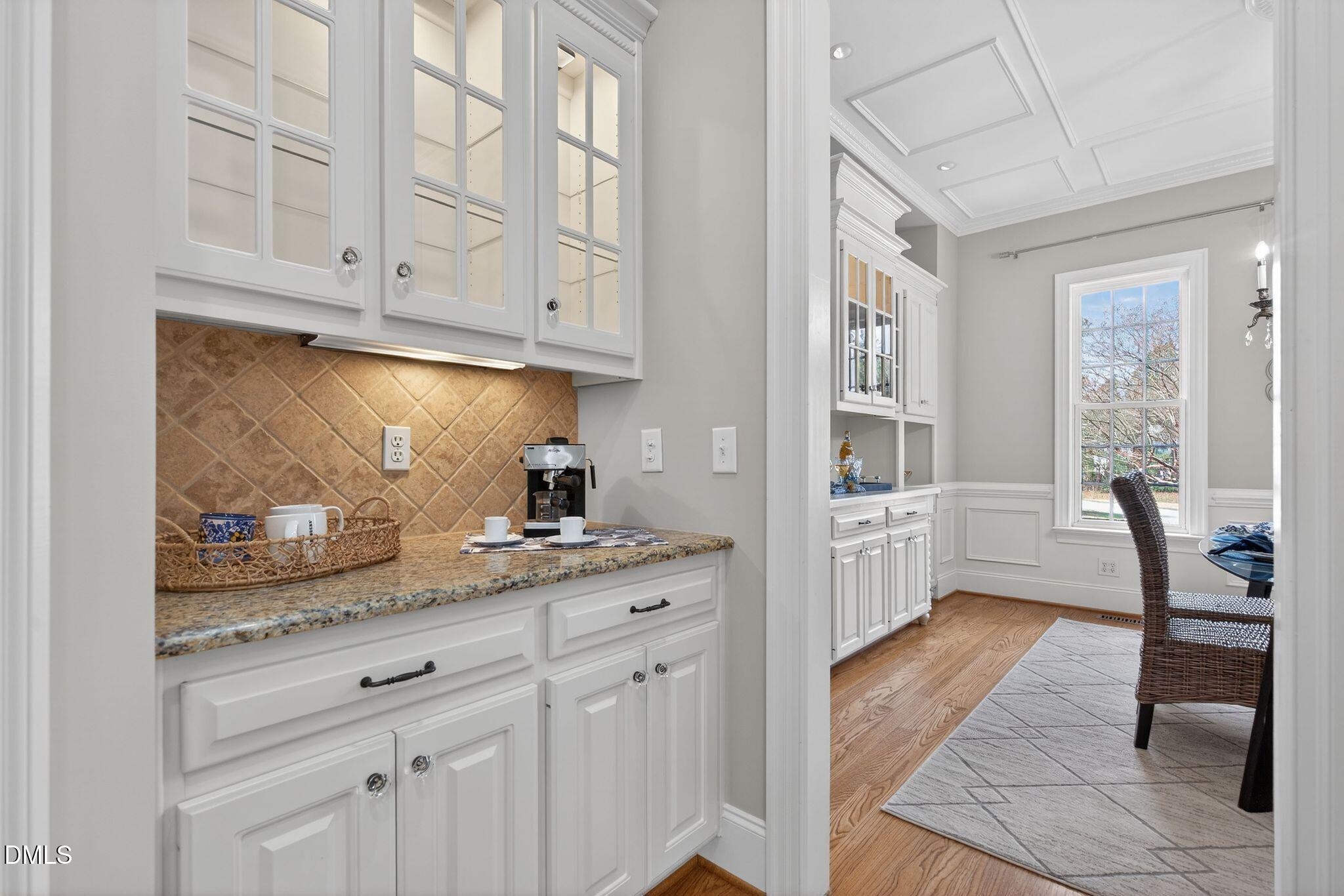 1609 Holland Road Fuquay-Varina, NC 27526 - Photo 22 of 79 a kitchen with granite countertop white cabinets and white appliances