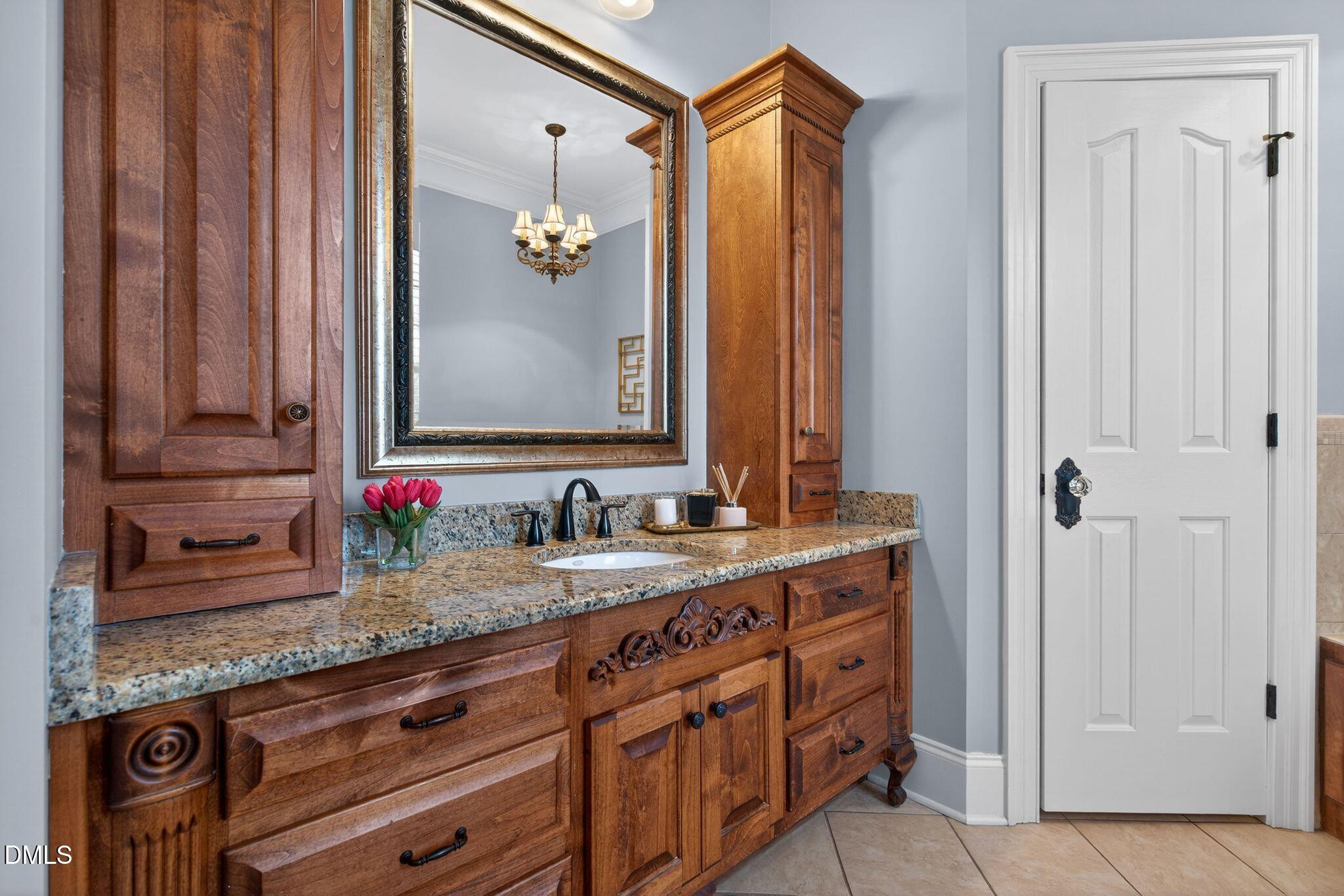 1609 Holland Road Fuquay-Varina, NC 27526 - Photo 32 of 79 a bathroom with a granite countertop sink and a mirror