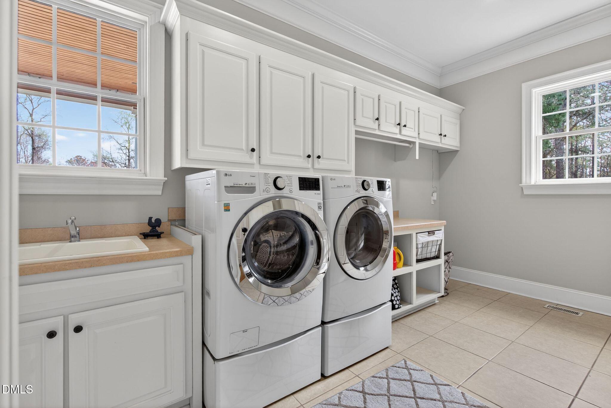 1609 Holland Road Fuquay-Varina, NC 27526 - Photo 34 of 79 a utility room with dryer and washer