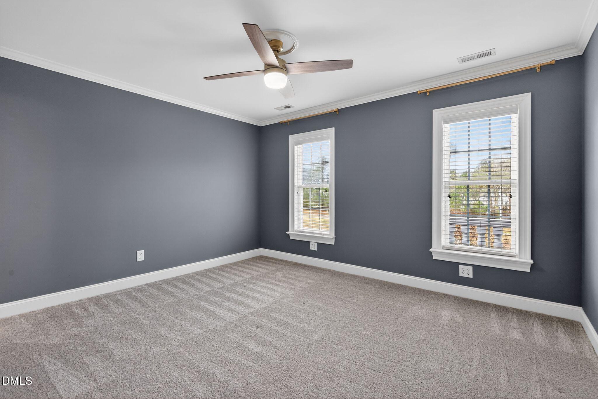 1609 Holland Road Fuquay-Varina, NC 27526 - Photo 38 of 79 an empty room with windows and ceiling fan