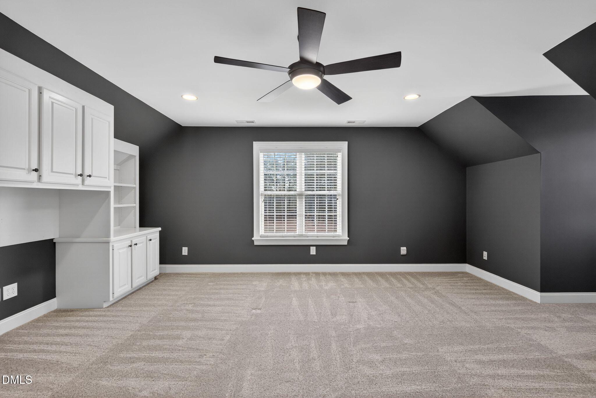 1609 Holland Road Fuquay-Varina, NC 27526 - Photo 40 of 79 a view of an empty room with a window and a fireplace