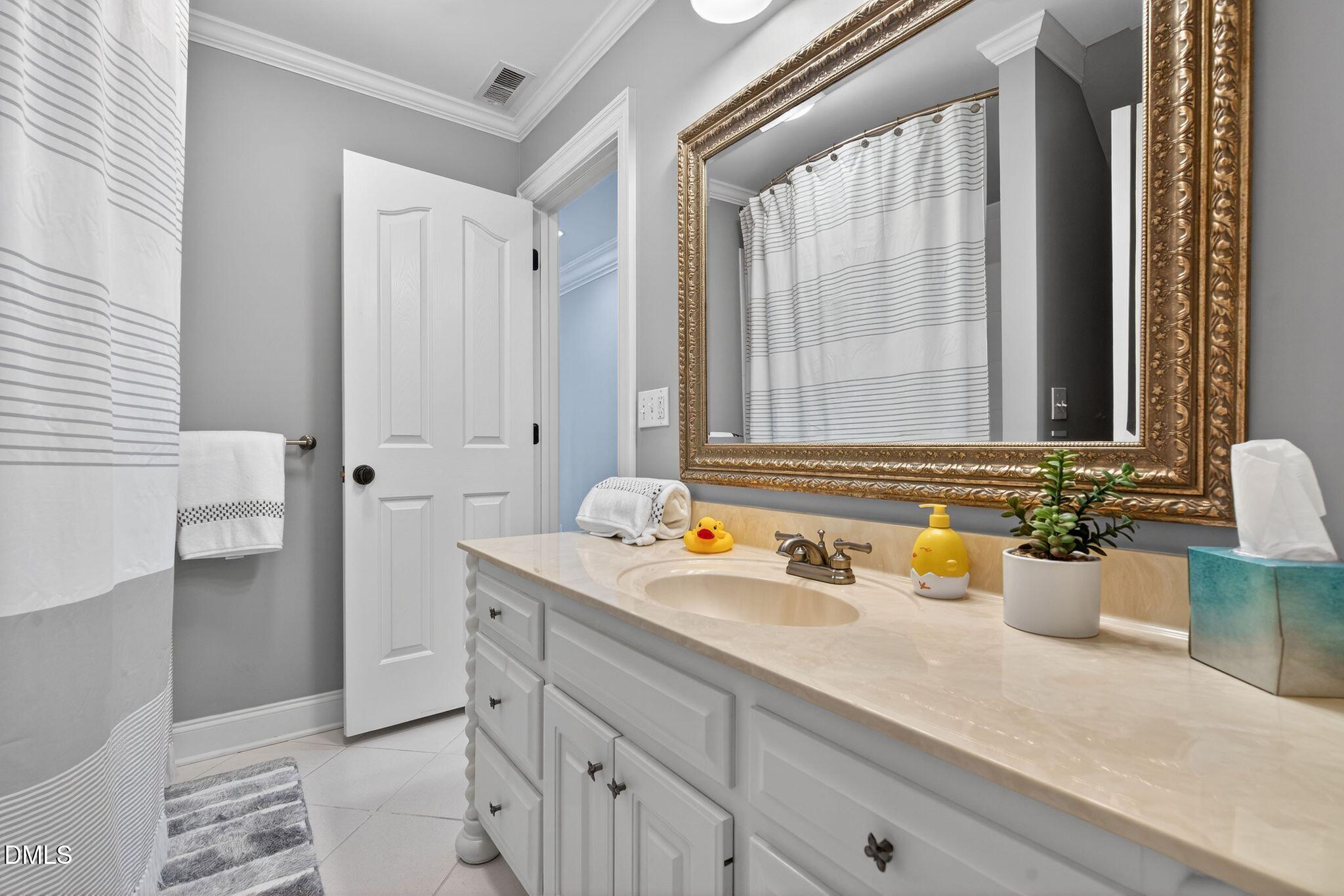 1609 Holland Road Fuquay-Varina, NC 27526 - Photo 45 of 79 a bathroom with a sink and a mirror
