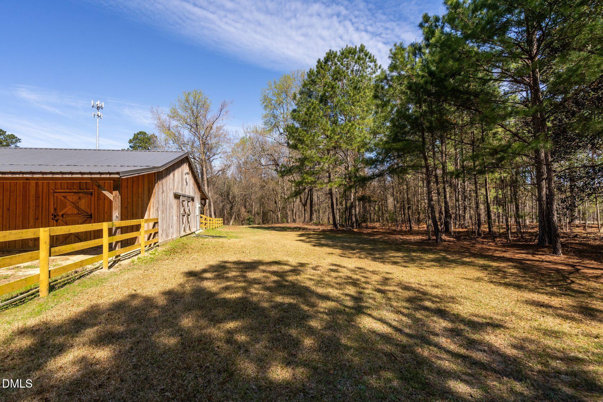 1609 Holland Road Fuquay-Varina, NC 27526 - Photo 65 of 79 a view of a house with backyard and tree
