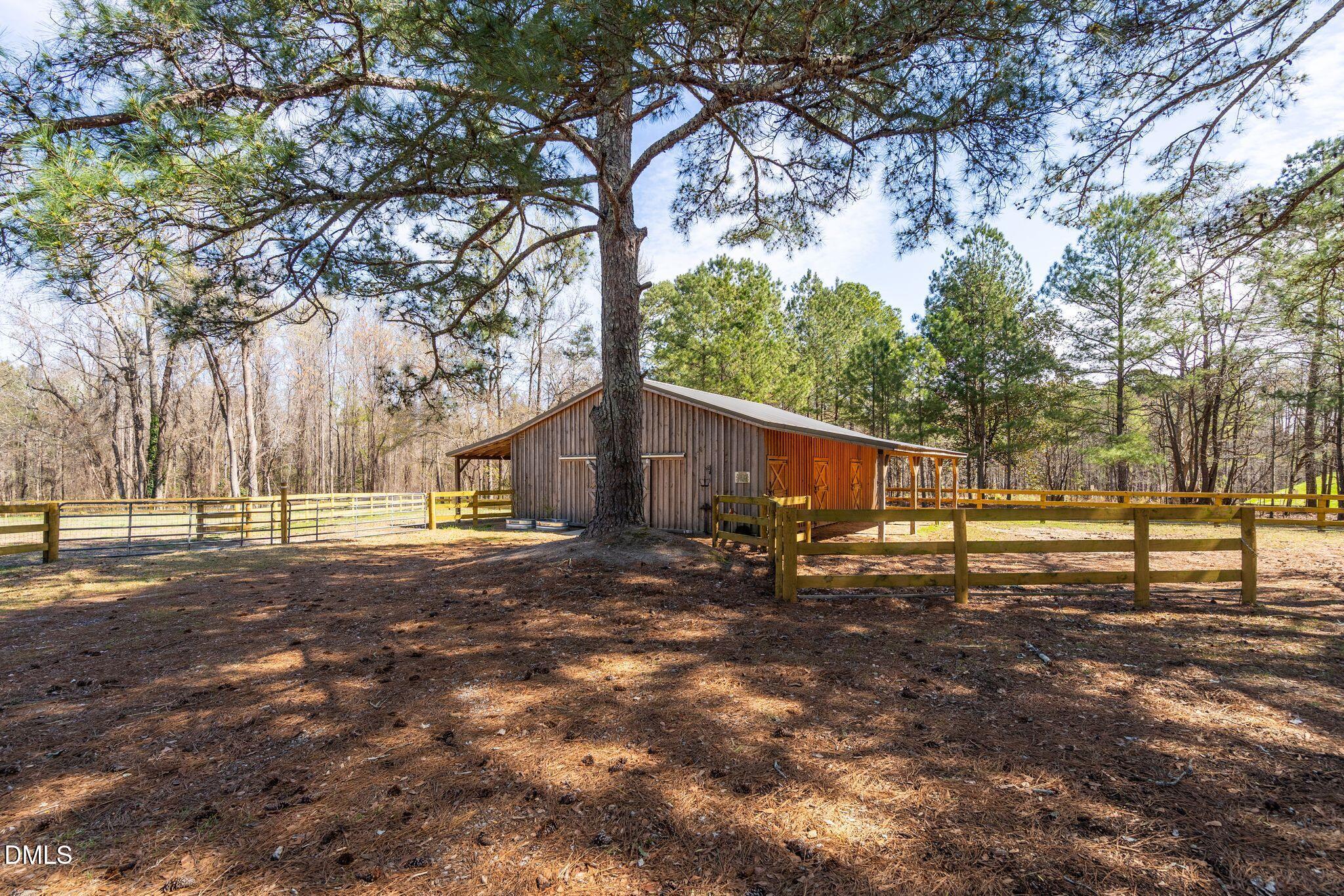1609 Holland Road Fuquay-Varina, NC 27526 - Photo 70 of 79 a backyard of a house with lots of green space