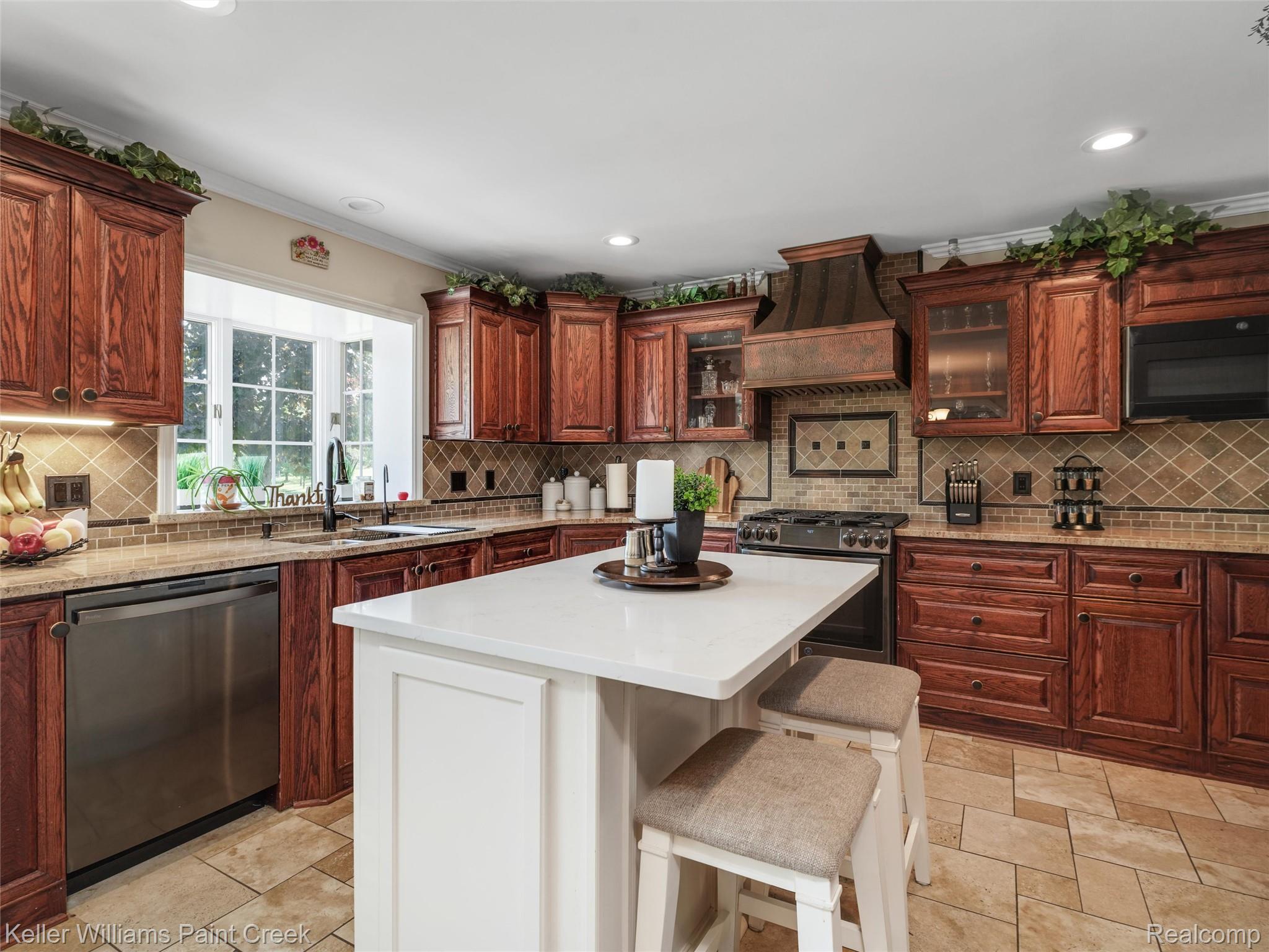 5813 36 Mile Road Romeo, MI 48065 - Photo 8 of 81 Kitchen featuring rich wood cabinetry, granite countertops, and a white island