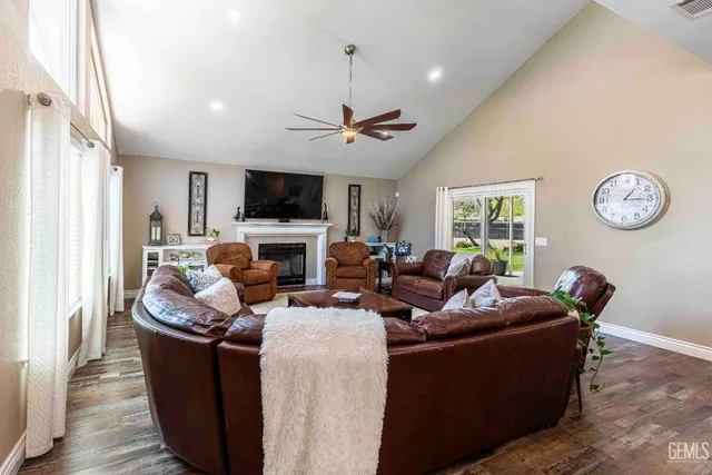 a living room with fireplace furniture and a flat screen tv