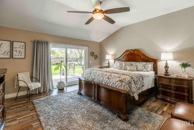 a bedroom with a bed wooden floor and window