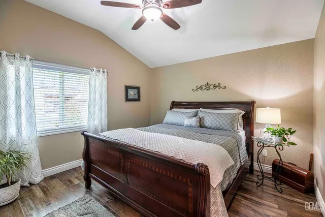 a bedroom with a bed and a potted plant