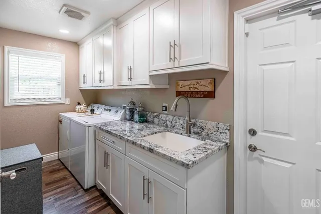 a kitchen with a sink cabinets and window