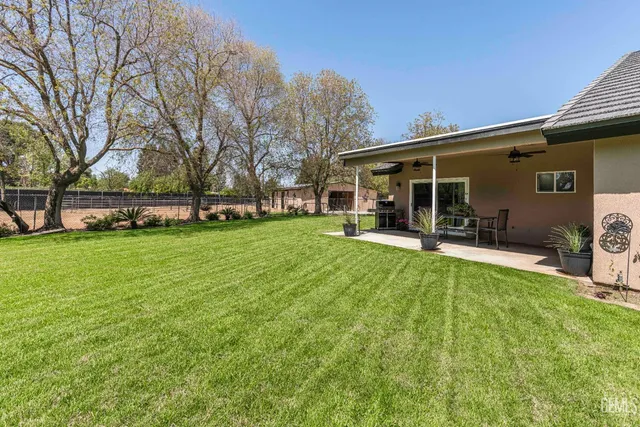 a view of a house with a yard and sitting area
