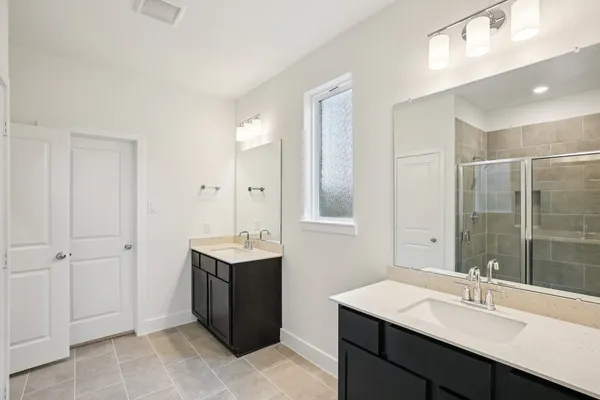 a bathroom with a sink double vanity and a mirror