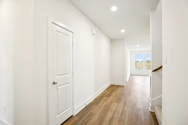 a view of hallway with wooden floor