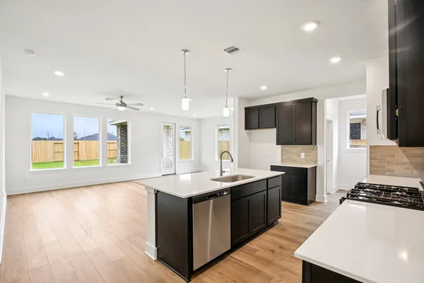 a kitchen with stainless steel appliances granite countertop a stove and a sink