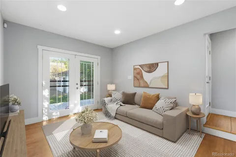 a living room with furniture and a wooden floor