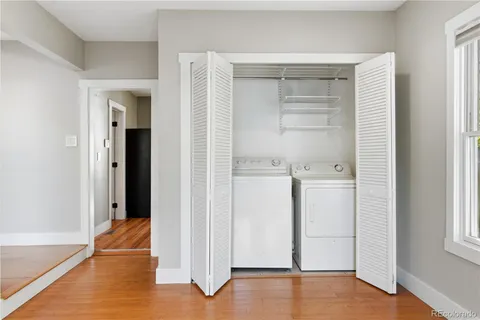 a view of walk in closet with empty racks