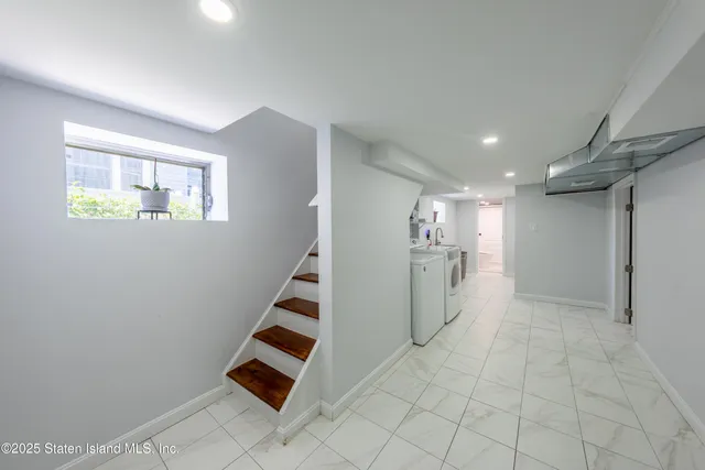 a view of an empty room with stairs and ventilation