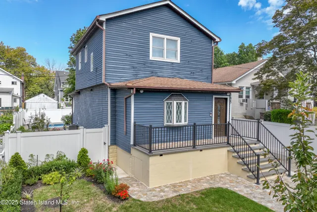 a view of brick house with a yard