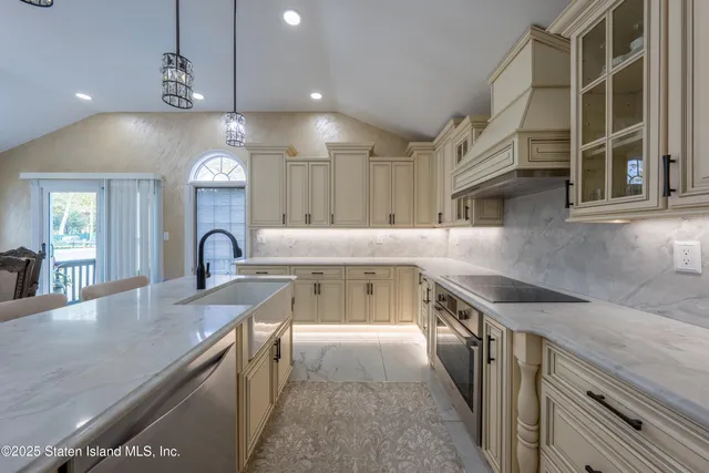 a open kitchen with granite countertop a stove and a sink