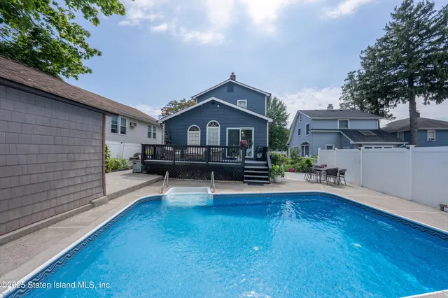 a view of a house with a patio and a yard