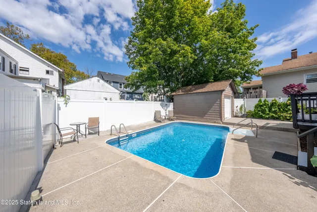 a view of a patio with table and chairs and potted plants