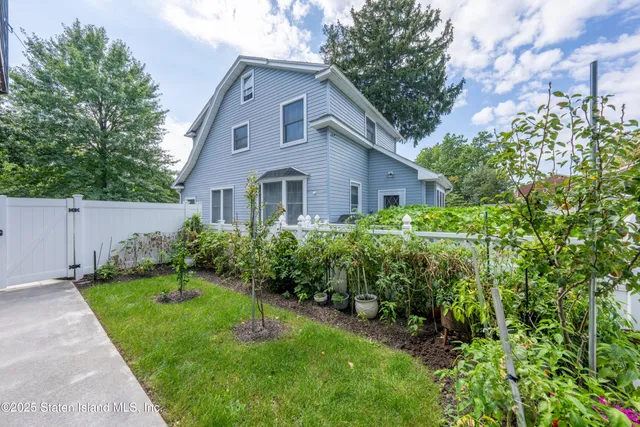 an aerial view of a house with garden space and street view