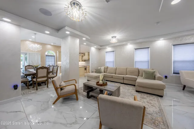 a living room with furniture and a chandelier