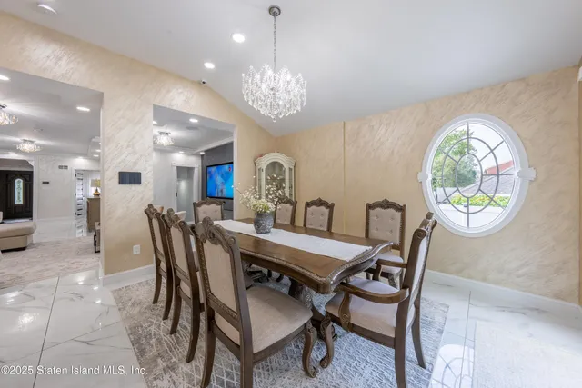 a view of a dining room with furniture and a chandelier