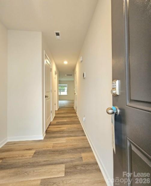 6012 Faron Way Charlotte, NC 28262 - Photo 4 of 9 a view of a hallway with wooden floor and staircase