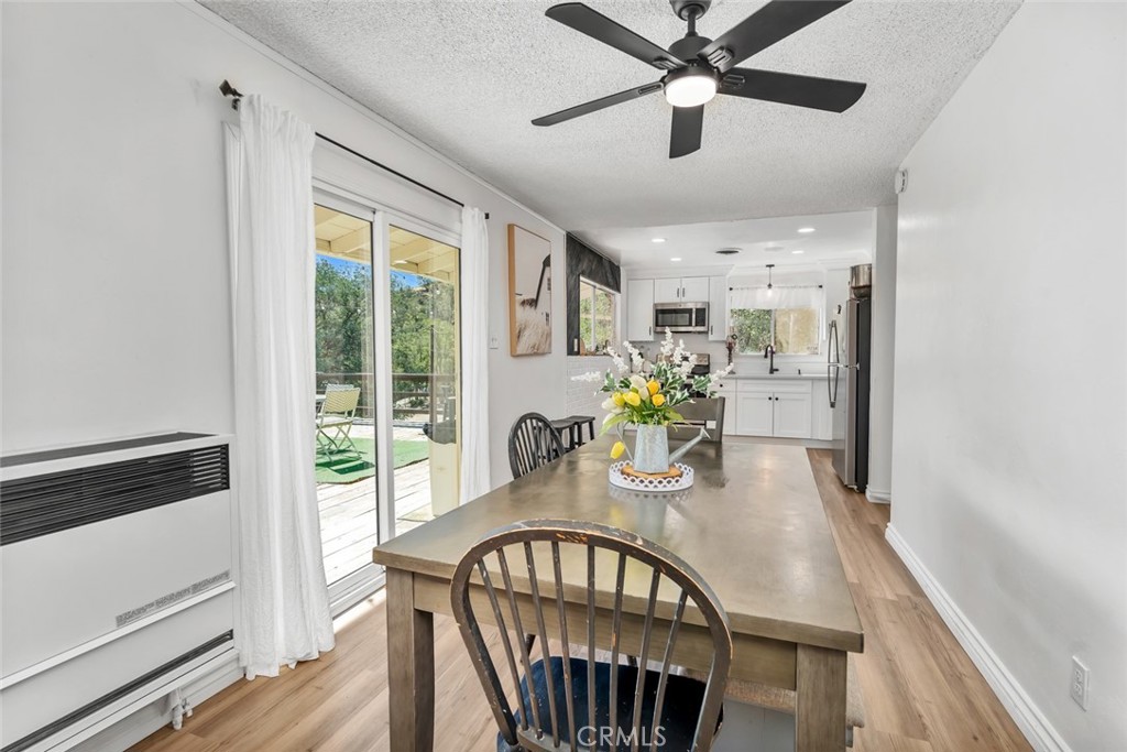 245 Mountain Shadow Road Wofford Heights, CA 93285 - Photo 11 of 72 a dining room with furniture a window and wooden floor