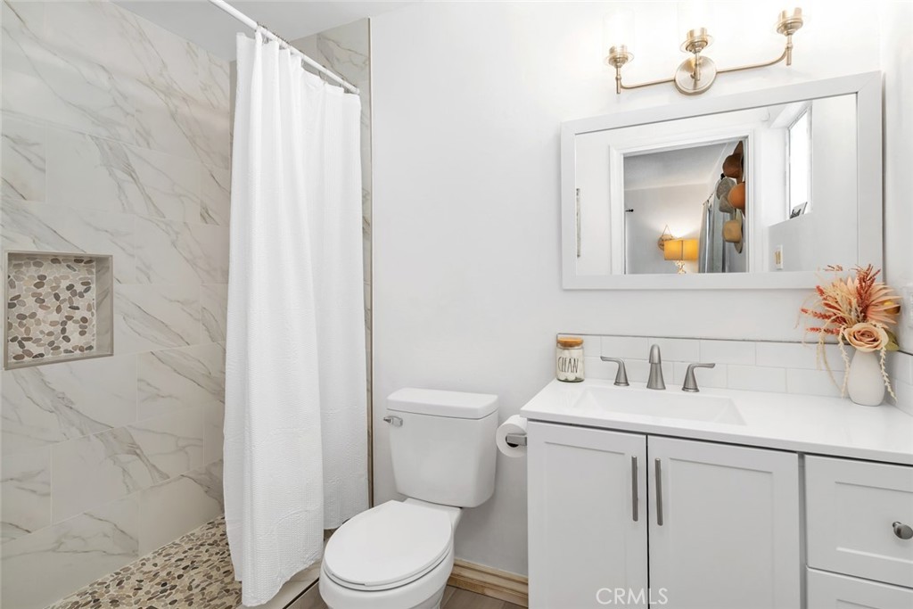 245 Mountain Shadow Road Wofford Heights, CA 93285 - Photo 13 of 72 a bathroom with a sink vanity mirror and toilet
