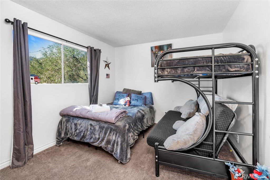 245 Mountain Shadow Road Wofford Heights, CA 93285 - Photo 14 of 72 a bedroom with bed and a window