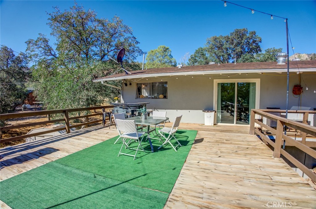 245 Mountain Shadow Road Wofford Heights, CA 93285 - Photo 20 of 72 a view of a house with backyard sitting area and garden