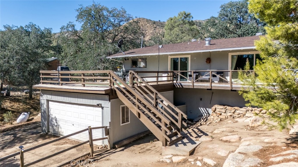245 Mountain Shadow Road Wofford Heights, CA 93285 - Photo 24 of 72 a view of a patio with a table chairs and a barbeque