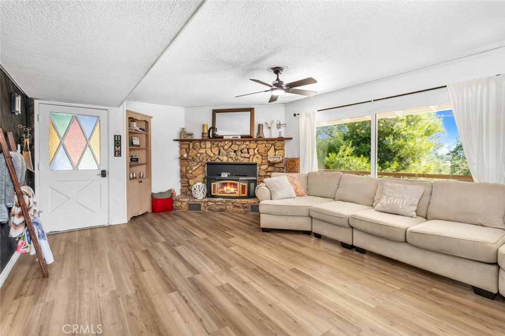 245 Mountain Shadow Road Wofford Heights, CA 93285 - Photo 5 of 72 a living room with furniture and a fireplace