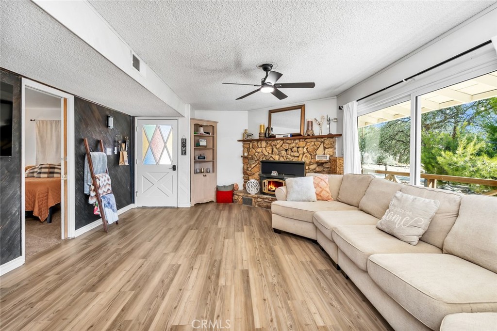 245 Mountain Shadow Road Wofford Heights, CA 93285 - Photo 6 of 72 a living room with furniture fireplace and a large window