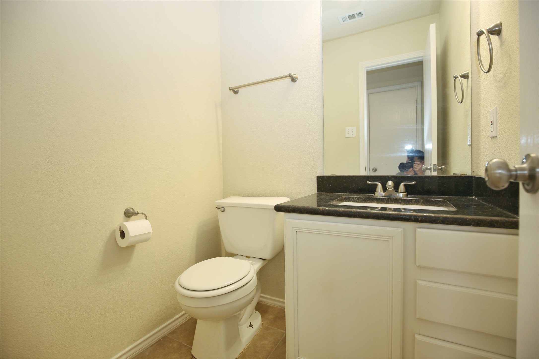 213 Rim Rock Drive Leander, TX 78641 - Photo 11 of 21 a bathroom with a granite countertop sink and a toilet