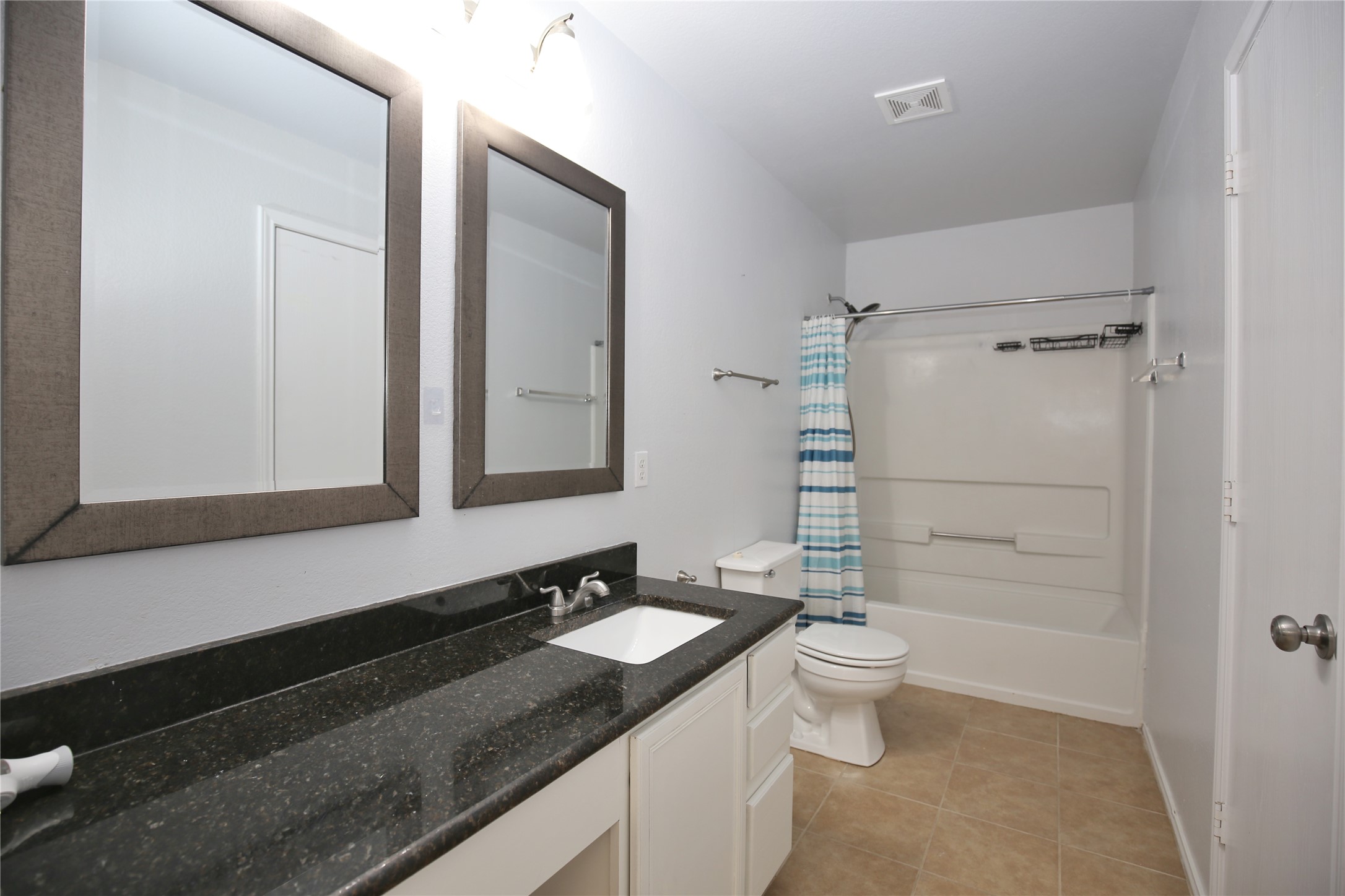 213 Rim Rock Drive Leander, TX 78641 - Photo 14 of 21 a bathroom with a granite countertop sink toilet and shower