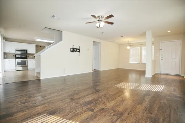 wooden floor in an empty room with a window