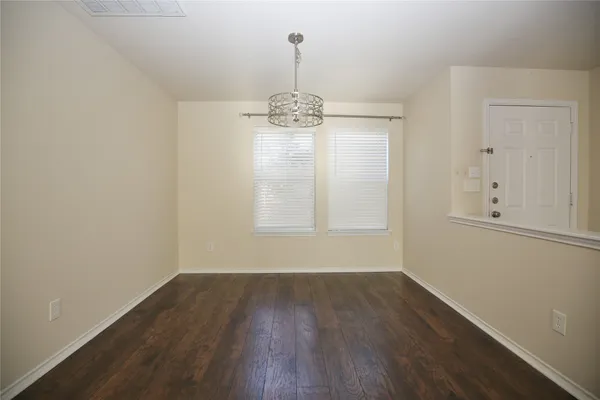 a refrigerator freezer sitting in a kitchen with white cabinets