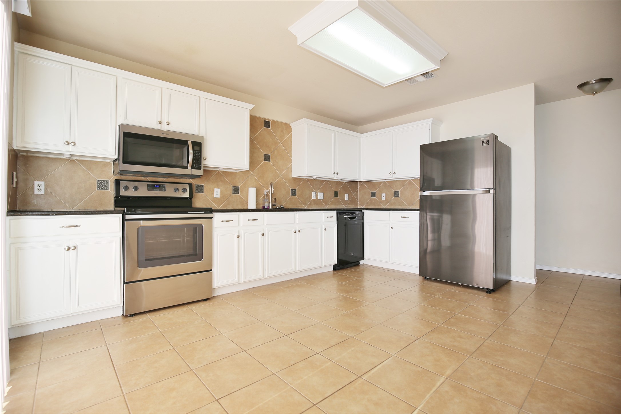 213 Rim Rock Drive Leander, TX 78641 - Photo 10 of 21 a kitchen with stainless steel appliances granite countertop a stove top oven a refrigerator and a sink