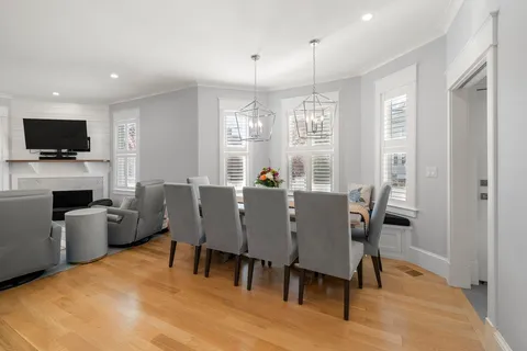 a view of a dining room with furniture window and wooden floor
