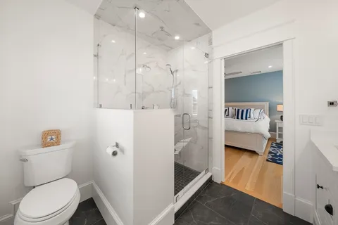 a en suite bathroom with a toilet sink and a shower