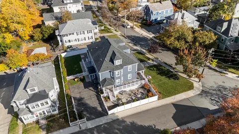 an aerial view of a house with a yard basket ball court and outdoor seating