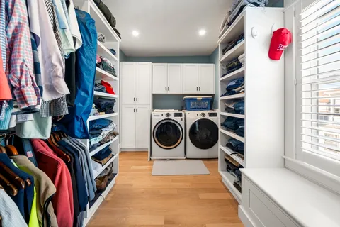 a view of walk in closet with clothes and shoes