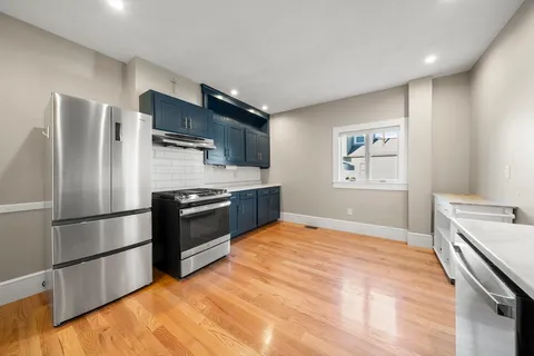a kitchen with stainless steel appliances and a refrigerator