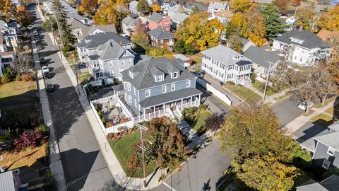an aerial view of residential houses with outdoor space