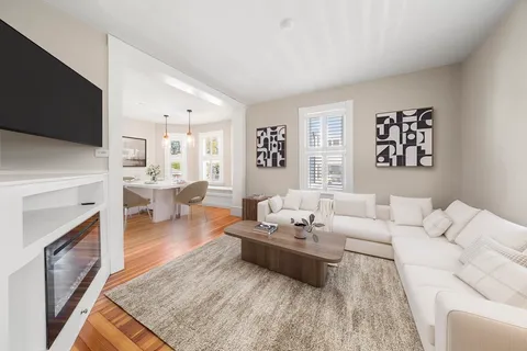 a living room with furniture fireplace and flat screen tv