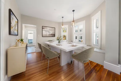 a view of a dining room with furniture window and wooden floor